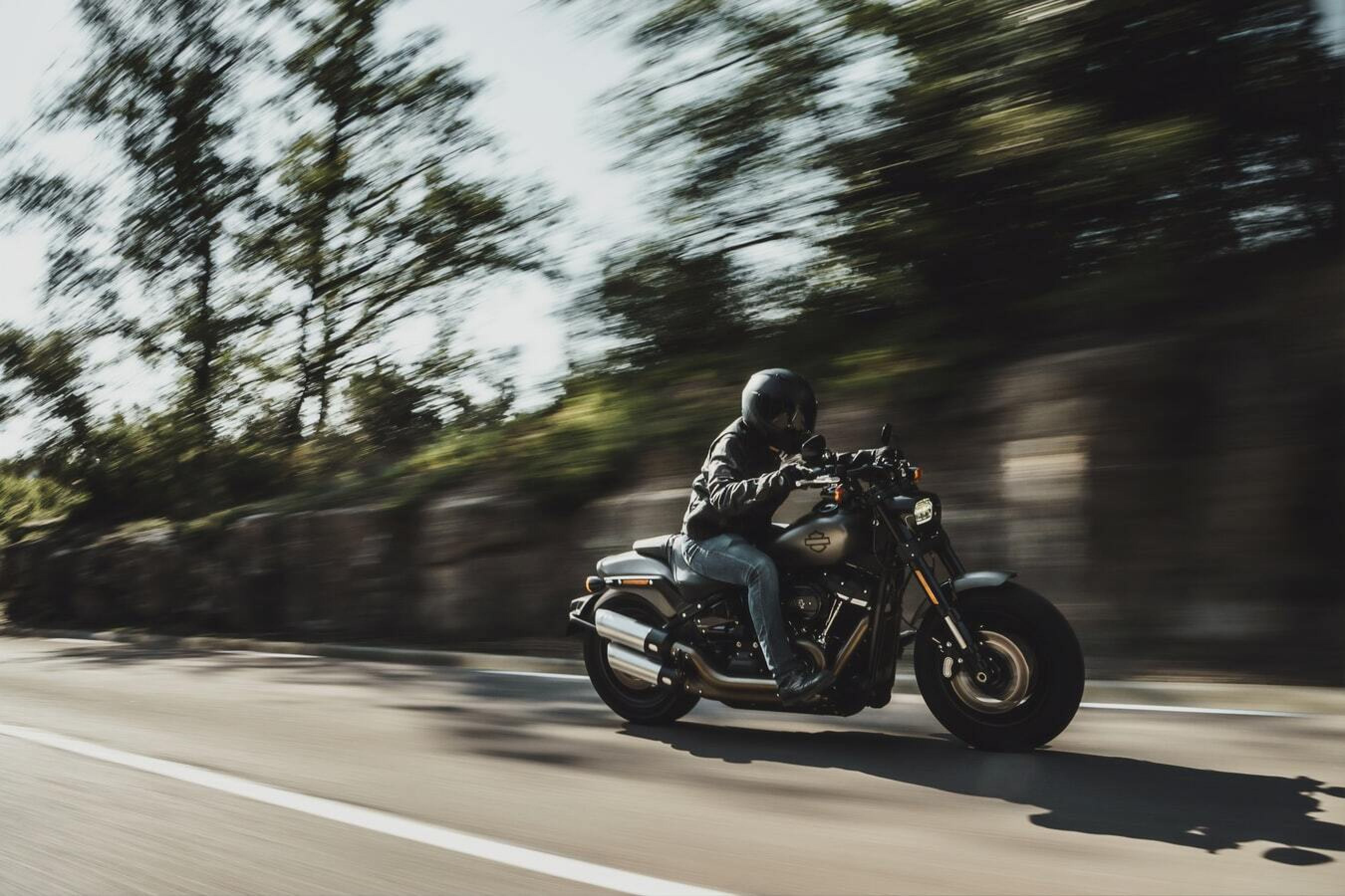 Decorative image of a motor cyclist, representing the speed of a creative automation platform